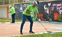 Florida Power & Light Company (FPL) volunteers Technical Specialist II Arturo Perez (left) and Leader Customer Outreach Amy Bonilla Torres (right) paints the recreational space of the Center for Adolescent Treatment Services in Pembroke Pines as part of F