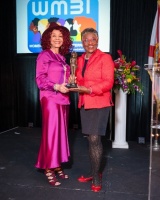 Ms. Anne McNeill (right) receiving the Trailblazing Women 2022 Award from Ms. Marie R. Gill