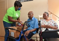 Florida Power & Light Company (FPL) Community Relations Specialist Darlyne Jean-Charles (left), FPL External Affairs Manager Christine Shaw (far right) and Meals on Wheels South Florida Executive Director Mark Adler (far right) deliver hurricane preparedn