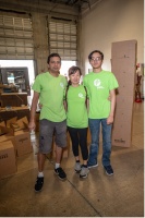 Florida Power & Light Company (FPL) Engineer John Rhoden (L) and his family joined dozens of volunteers on Nov. 19, at the 31st Annual 100 Black Men Thanksgiving Food Drive to pack hope for over 70,000 economically disadvantaged individuals in SOFL.